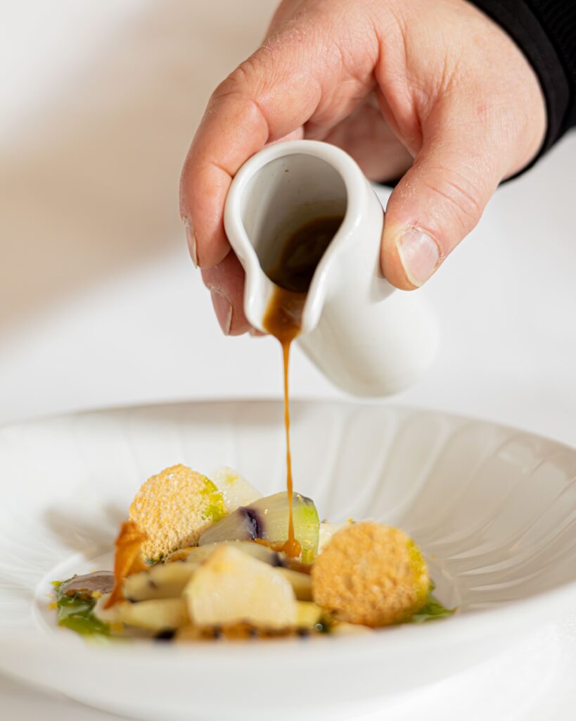 Sauce poured over one of the chef’s dishes